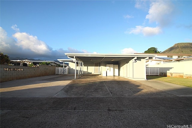 view of front facade featuring a carport and a mountain view