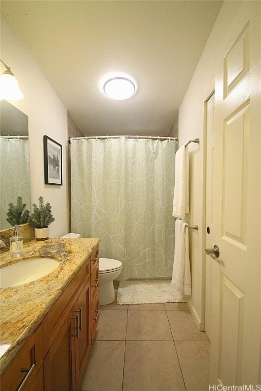 bathroom featuring toilet, tile patterned floors, and vanity