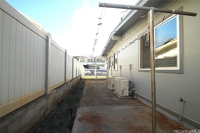 view of property exterior featuring ac unit and a patio area