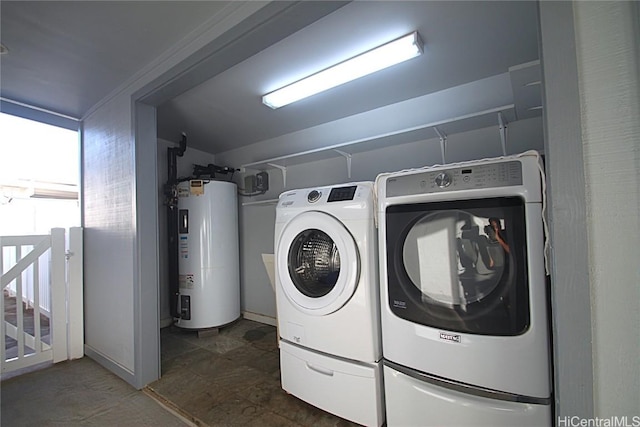 clothes washing area featuring washer and dryer and electric water heater