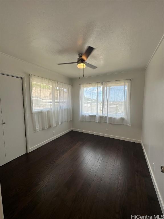 empty room featuring dark hardwood / wood-style floors and ceiling fan