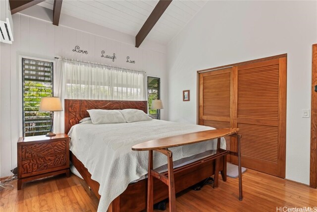 bedroom featuring wood ceiling, wood-type flooring, lofted ceiling with beams, and a closet