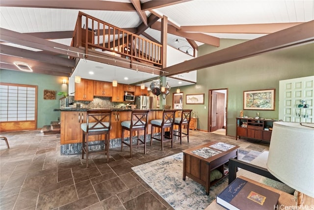 living room featuring vaulted ceiling with beams