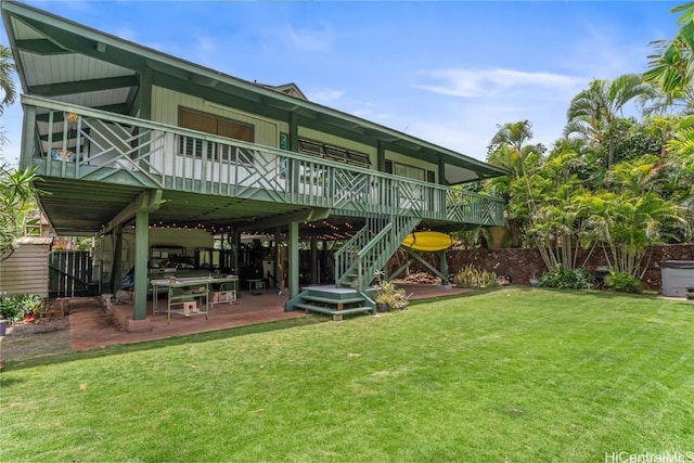 back of house with a wooden deck, a yard, and a patio