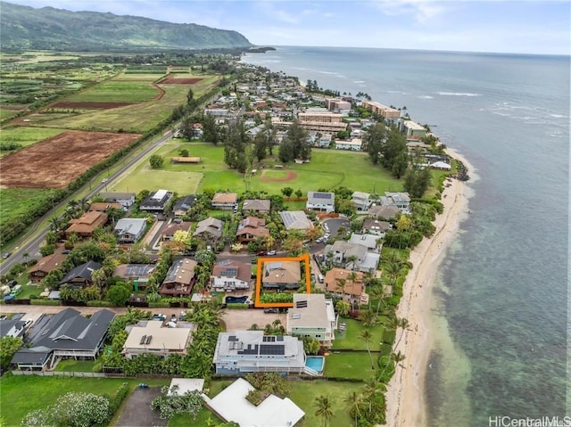 birds eye view of property featuring a water view and a beach view