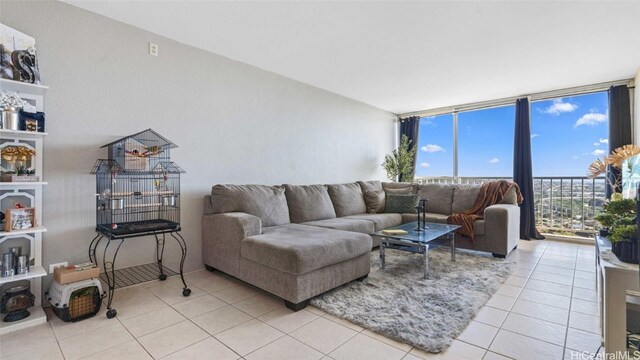 living room with expansive windows and light tile patterned floors