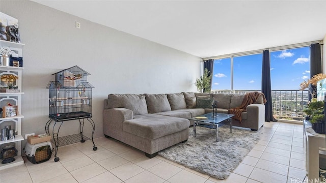 living area featuring light tile patterned floors and a wall of windows