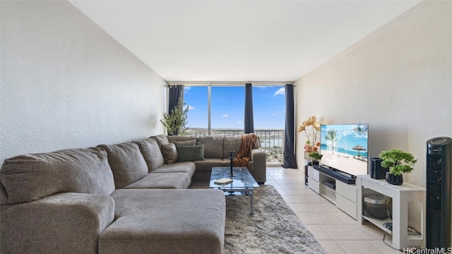 living room with floor to ceiling windows and light tile patterned floors