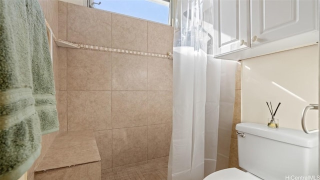 bathroom with curtained shower and toilet