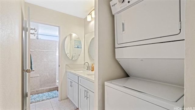 laundry room featuring sink, light tile patterned floors, and stacked washer and clothes dryer