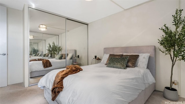 bedroom featuring light carpet and a closet