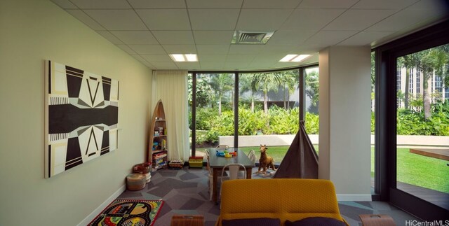 sunroom / solarium featuring a drop ceiling