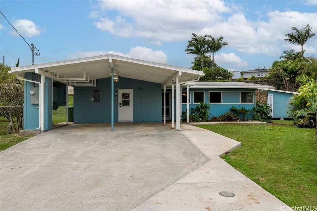 single story home with a carport and a front lawn