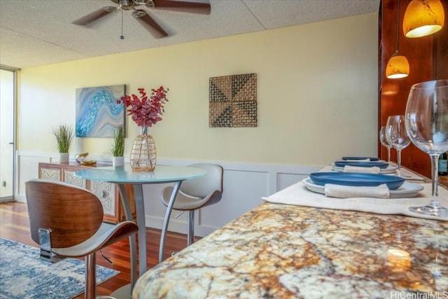 dining room featuring wood-type flooring and ceiling fan