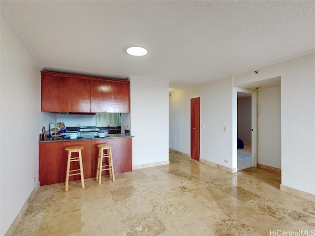 kitchen featuring kitchen peninsula and a textured ceiling