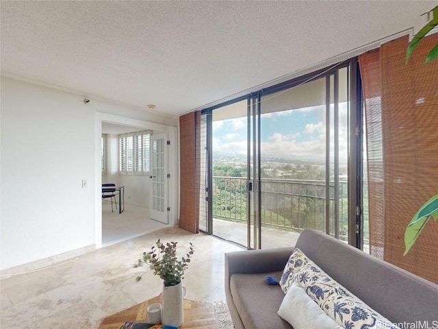 living room with expansive windows and a textured ceiling