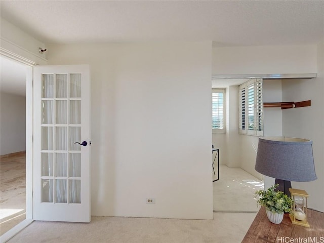 carpeted empty room featuring french doors