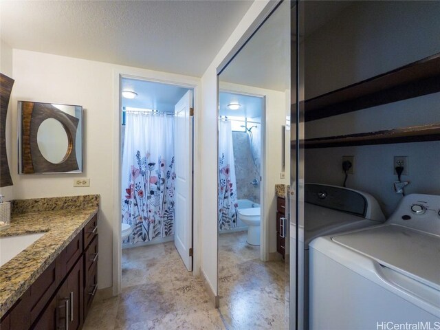 washroom with sink and independent washer and dryer