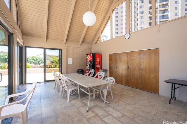 dining room featuring beamed ceiling, high vaulted ceiling, wooden ceiling, and a wealth of natural light