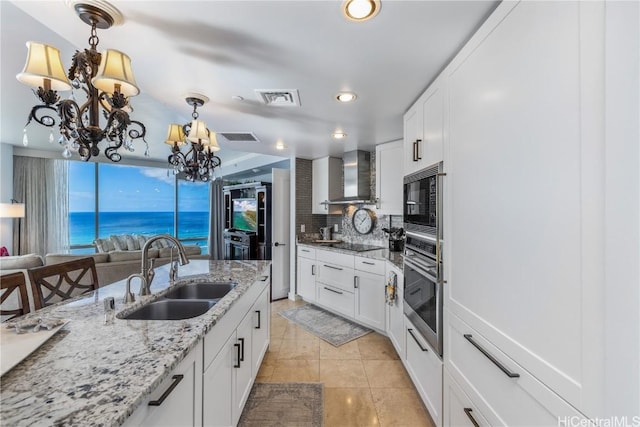 kitchen featuring white cabinetry, sink, wall chimney exhaust hood, and black appliances