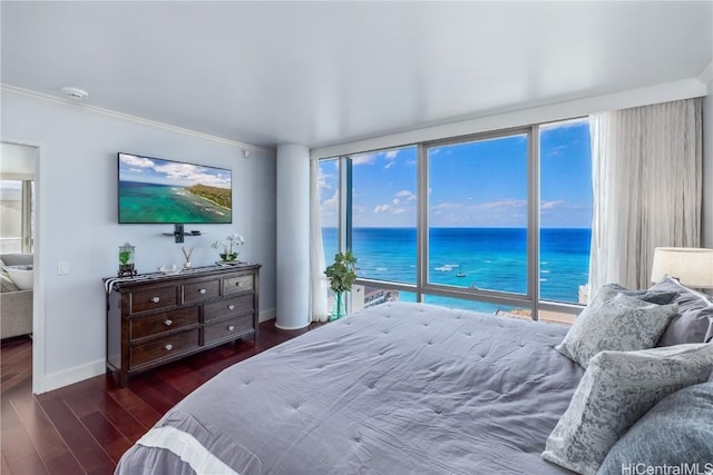 bedroom with multiple windows, crown molding, and dark hardwood / wood-style flooring