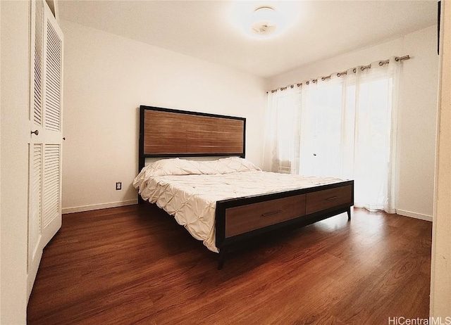 bedroom featuring dark wood-type flooring and baseboards