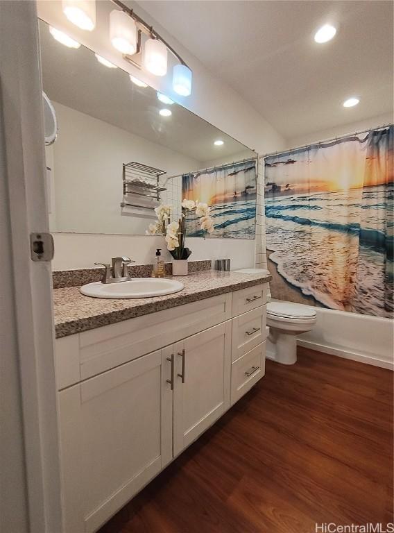 full bath featuring vanity, shower / bath combination with curtain, toilet, and wood finished floors