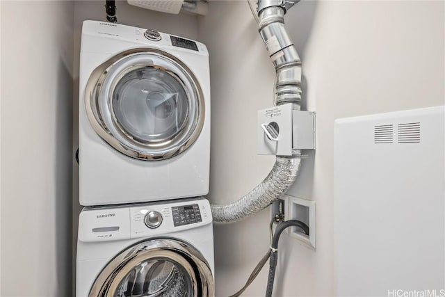 washroom featuring stacked washing maching and dryer