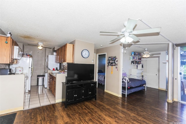 1260 Richard Ln Unit B405, Honolulu, HI 96819 - kitchen featuring a ceiling fan, white appliances, wood finished floors, brown cabinets, and light countertops