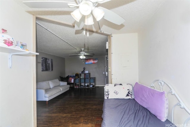 living room with dark hardwood / wood-style flooring, a textured ceiling, and ceiling fan