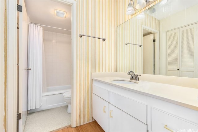 full bathroom featuring vanity, toilet, wood-type flooring, and shower / tub combo with curtain