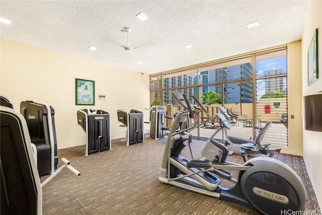 exercise room featuring carpet floors and a textured ceiling