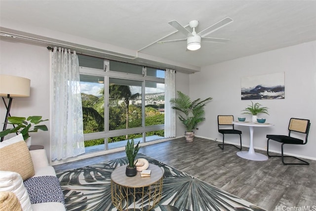 sitting room with hardwood / wood-style floors and ceiling fan