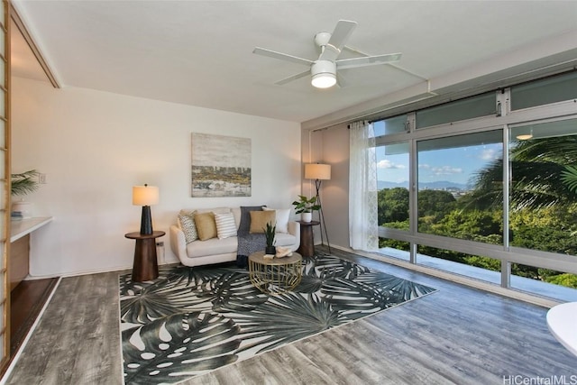 living area with ceiling fan and hardwood / wood-style flooring