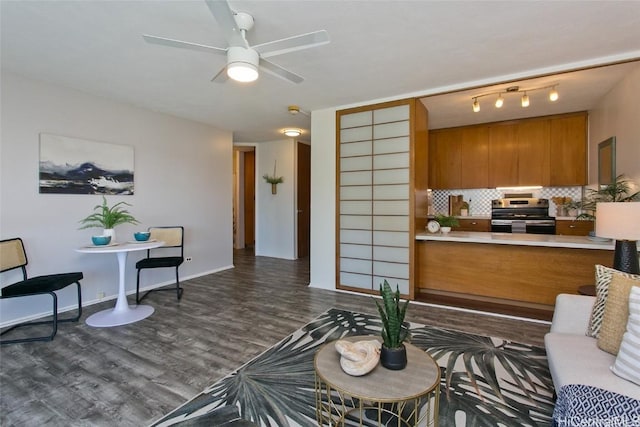 living room featuring ceiling fan and dark hardwood / wood-style flooring