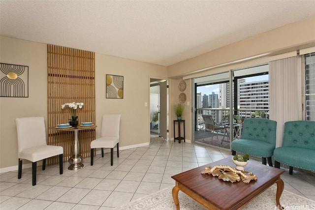 living room featuring light tile patterned flooring and a textured ceiling