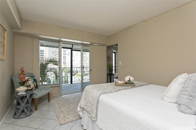 bedroom featuring light tile patterned floors, a textured ceiling, and access to outside