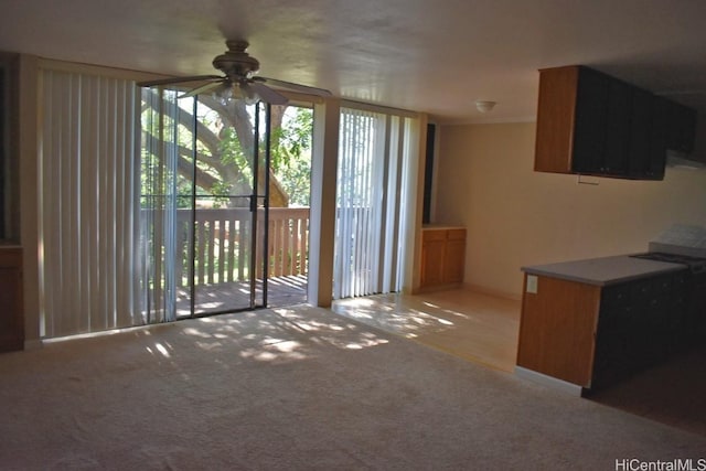 unfurnished living room with ceiling fan and light carpet