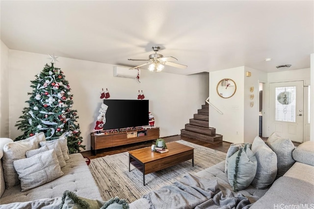 living room with a wall mounted air conditioner, hardwood / wood-style flooring, and ceiling fan