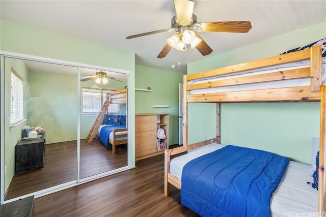 bedroom with dark hardwood / wood-style flooring, ceiling fan, and a closet