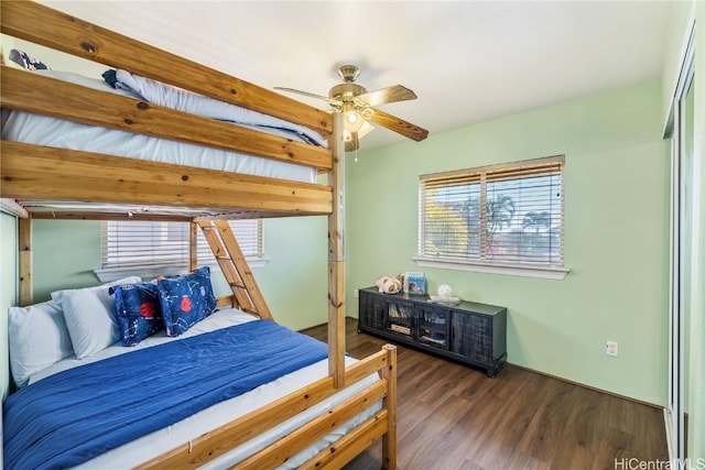 bedroom with ceiling fan and dark wood-type flooring