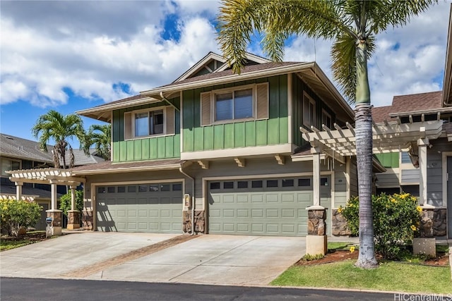 view of front of home with a pergola and a garage