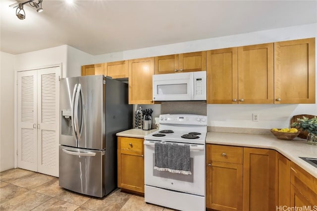 kitchen with light tile patterned floors and white appliances