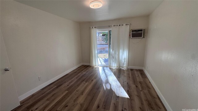 87-141 Kulahelela Pl, Waianae, HI 96792 - unfurnished room featuring a wall unit AC, wood finished floors, and baseboards