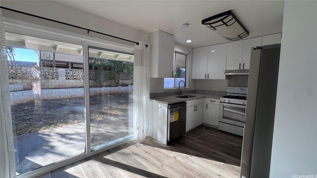 87-141 Kulahelela Pl, Waianae, HI 96792 - kitchen featuring white gas stove, under cabinet range hood, dishwasher, a sink, and dark wood-style flooring
