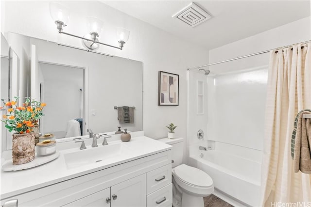 full bathroom featuring hardwood / wood-style flooring, shower / bath combination with curtain, toilet, and vanity