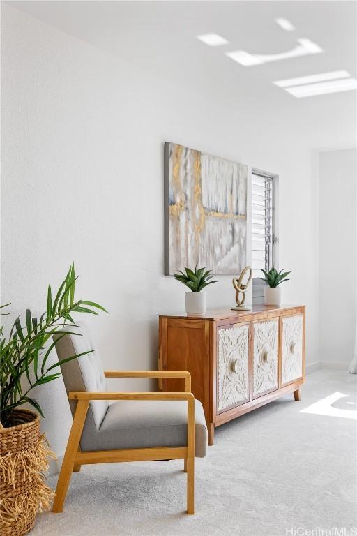 living area featuring light carpet