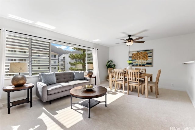 carpeted living room featuring ceiling fan