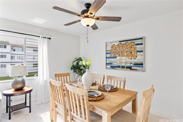 dining room featuring ceiling fan and light colored carpet