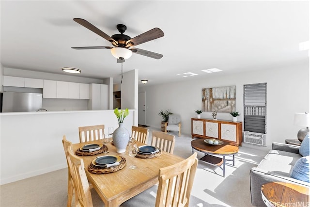 carpeted dining room with ceiling fan